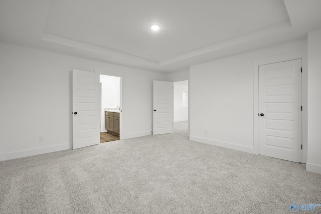 188 Chesire Cove Ln, New Market, AL 35759 - unfurnished bedroom with a raised ceiling, carpet flooring, baseboards, and ensuite bath