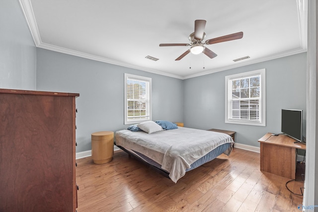 bedroom featuring hardwood / wood-style flooring, ceiling fan, multiple windows, and crown molding