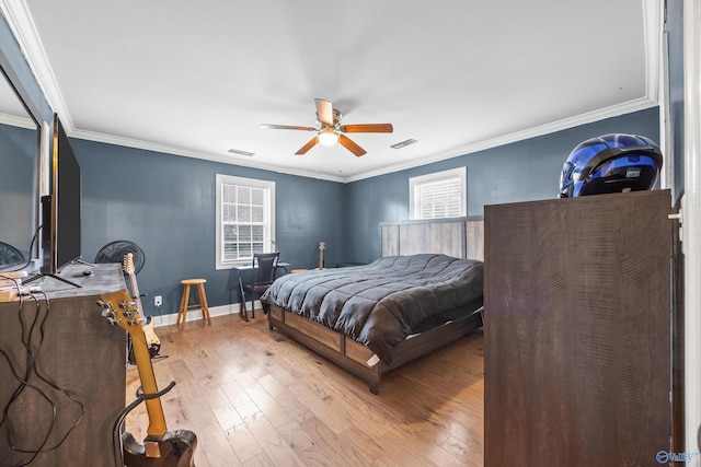 bedroom with light hardwood / wood-style floors, ceiling fan, and ornamental molding