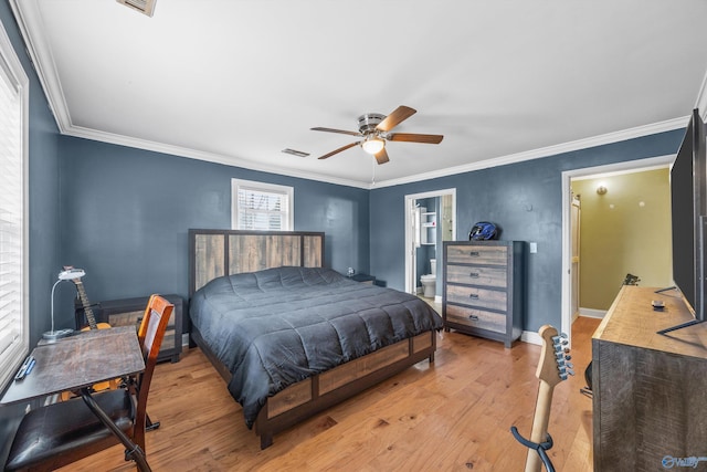 bedroom featuring ceiling fan, connected bathroom, light wood-type flooring, and ornamental molding