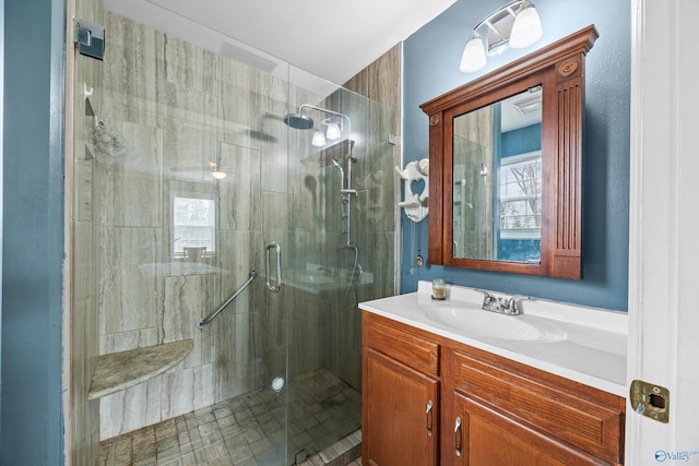 bathroom featuring vanity and a shower with door