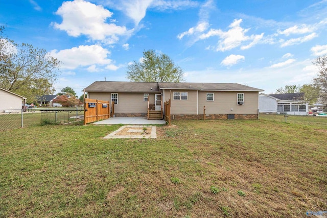 rear view of property with a yard and a patio area