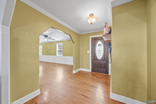 entryway featuring ornamental molding, light hardwood / wood-style floors, a healthy amount of sunlight, and ceiling fan