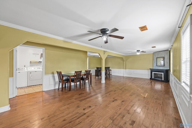 interior space featuring hardwood / wood-style floors, a healthy amount of sunlight, ceiling fan, and washing machine and clothes dryer