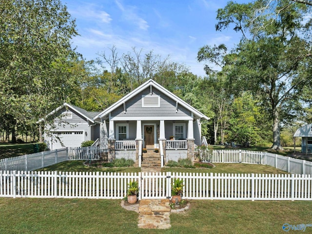 view of front of property with a porch, a front yard, and a garage