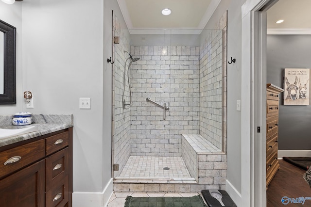 bathroom featuring vanity, an enclosed shower, ornamental molding, and hardwood / wood-style floors