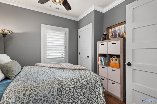 bedroom featuring crown molding, dark hardwood / wood-style floors, and ceiling fan