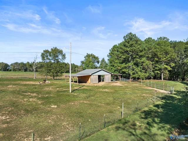 view of yard featuring a rural view and an outdoor structure