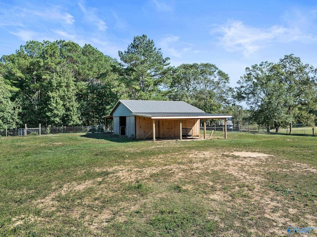 view of yard with a rural view and an outdoor structure