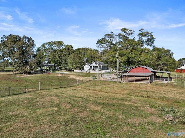 view of yard with an outdoor structure and a rural view