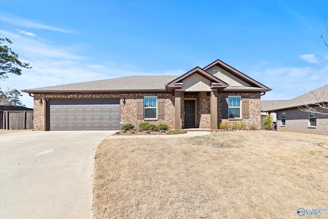 view of front facade featuring an attached garage, driveway, a front lawn, and brick siding