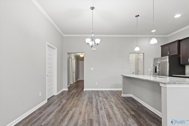 kitchen featuring baseboards, stainless steel fridge with ice dispenser, decorative light fixtures, light stone countertops, and dark brown cabinets