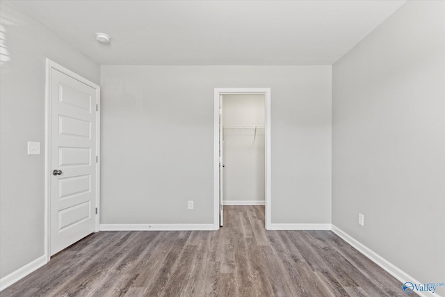 spare room with baseboards and light wood-style floors