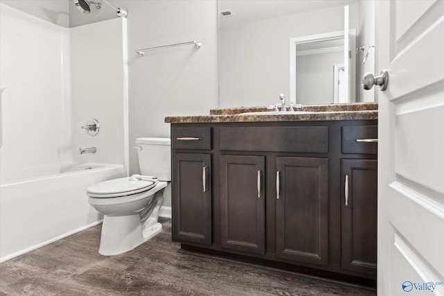 full bath with toilet, wood finished floors, visible vents, vanity, and shower / washtub combination