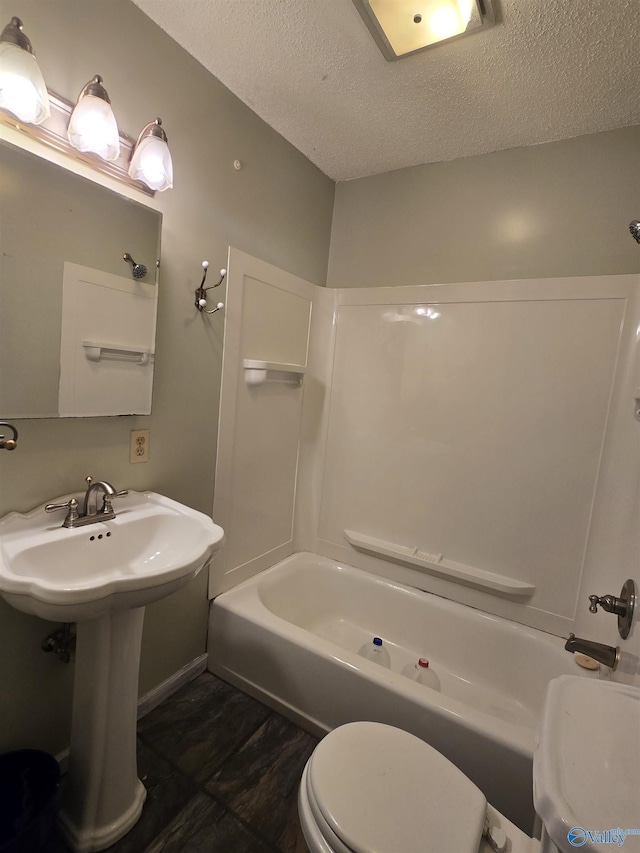 full bath featuring a textured ceiling, toilet, and bathtub / shower combination