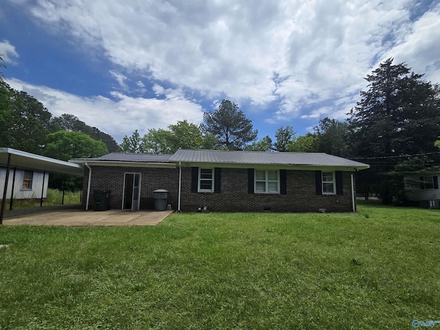 single story home featuring brick siding, a front lawn, metal roof, and a patio area
