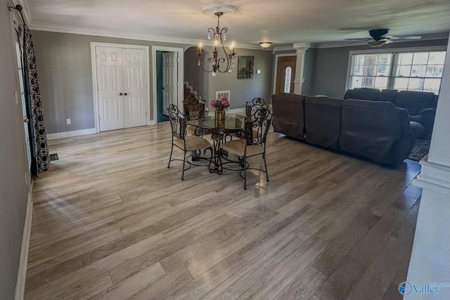 dining area featuring ornamental molding, baseboards, and light wood finished floors