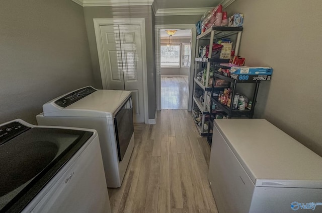 laundry area featuring laundry area, baseboards, light wood-style floors, ornamental molding, and independent washer and dryer