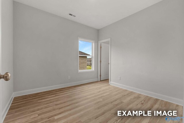 spare room featuring light wood-type flooring