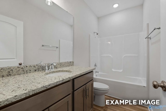 full bathroom featuring toilet, shower / washtub combination, vanity, and hardwood / wood-style flooring