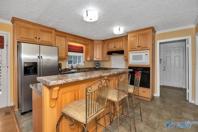 kitchen with stainless steel refrigerator with ice dispenser, white microwave, oven, and crown molding