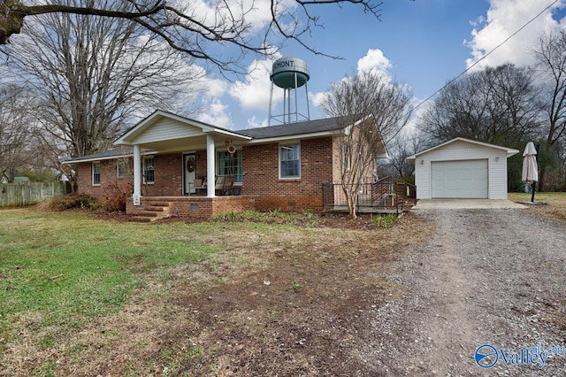 view of front of home with an outbuilding, a front lawn, covered porch, and a garage