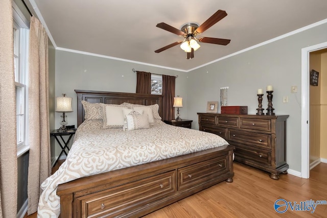 bedroom featuring ceiling fan, light wood-type flooring, and ornamental molding