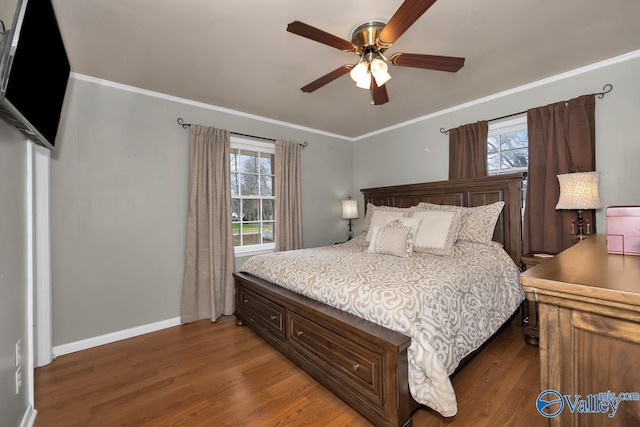 bedroom with hardwood / wood-style floors, ceiling fan, and ornamental molding