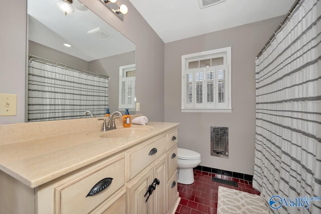 bathroom with tile patterned floors, vanity, toilet, and heating unit