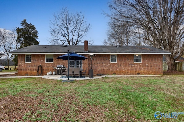 back of house with a lawn and a patio area