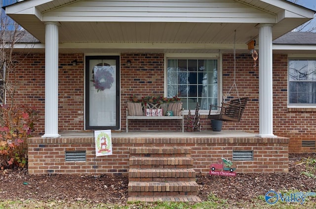 view of exterior entry with a porch