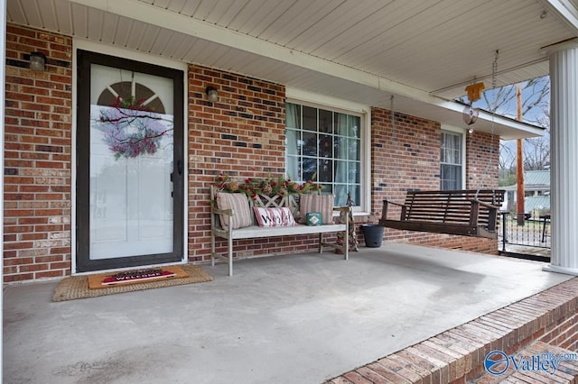 view of exterior entry with covered porch