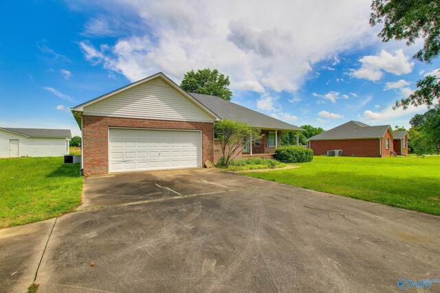 20886 Johnson Dr, Athens, AL 35613 - ranch-style home featuring concrete driveway, a garage, brick siding, and a front yard