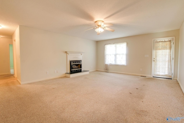20886 Johnson Dr, Athens, AL 35613 - unfurnished living room featuring ceiling fan, carpet flooring, baseboards, and a glass covered fireplace
