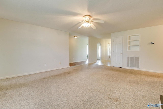 20886 Johnson Dr, Athens, AL 35613 - unfurnished room featuring visible vents, ceiling fan, carpet floors, arched walkways, and baseboards