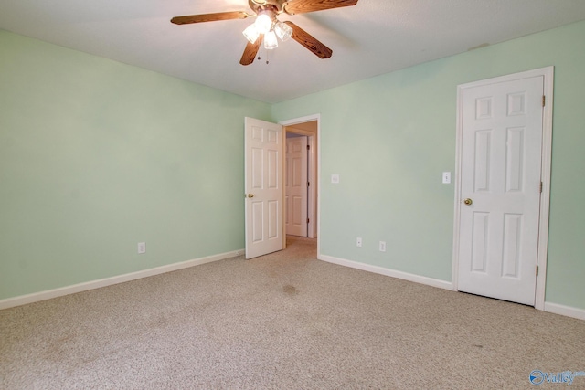 20886 Johnson Dr, Athens, AL 35613 - unfurnished bedroom featuring baseboards, light carpet, and a ceiling fan