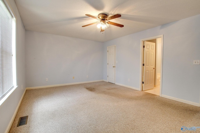 20886 Johnson Dr, Athens, AL 35613 - spare room featuring light carpet, baseboards, a ceiling fan, and visible vents