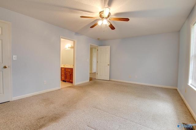 20886 Johnson Dr, Athens, AL 35613 - unfurnished bedroom with ensuite bath, light colored carpet, baseboards, and a ceiling fan