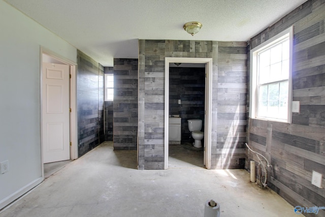 20886 Johnson Dr, Athens, AL 35613 - bathroom featuring toilet, concrete flooring, and wooden walls