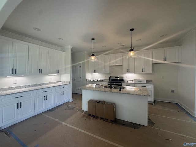 215 Dogwood Dr, Rogersville, AL 35652 - kitchen featuring white cabinetry, a center island with sink, decorative light fixtures, light stone countertops, and a sink