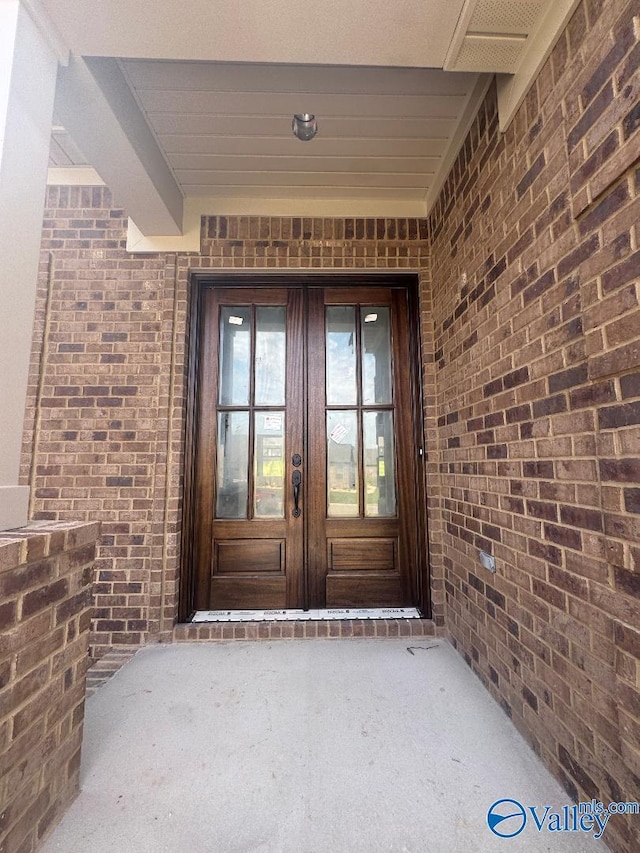 215 Dogwood Dr, Rogersville, AL 35652 - view of exterior entry featuring french doors and brick siding