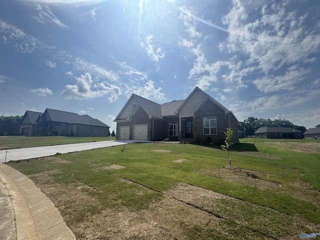 215 Dogwood Dr, Rogersville, AL 35652 - view of front of property featuring driveway, a garage, a front lawn, and brick siding