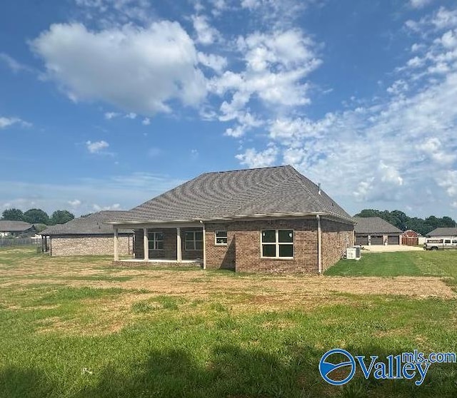 215 Dogwood Dr, Rogersville, AL 35652 - back of property with a yard and brick siding