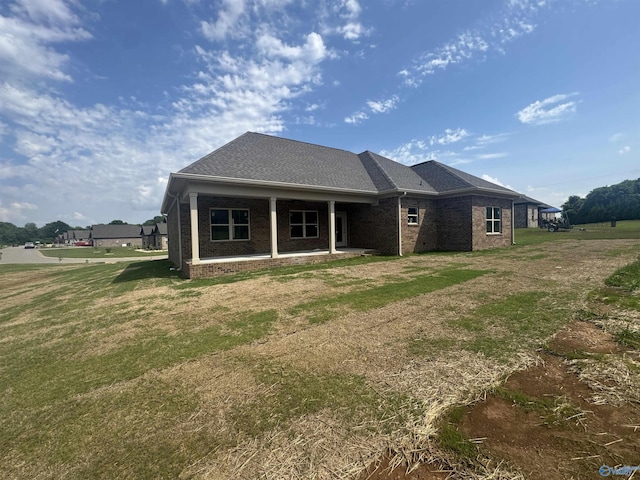215 Dogwood Dr, Rogersville, AL 35652 - rear view of property featuring brick siding, a lawn, and a patio area