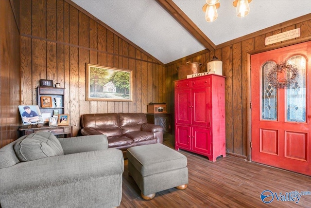 living room featuring hardwood / wood-style flooring, wooden walls, and lofted ceiling with beams