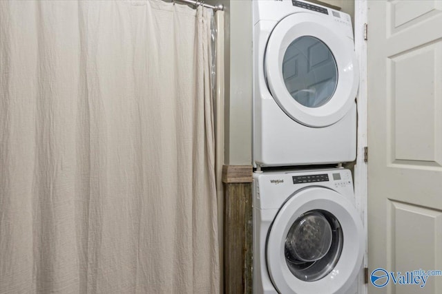 clothes washing area featuring stacked washer / drying machine