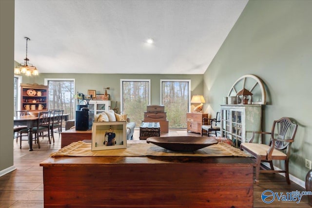 living room with wood-type flooring and a notable chandelier