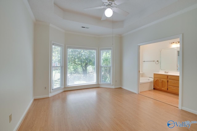 1102 Chesterfield Dr SE, Huntsville, AL 35803 - unfurnished bedroom with a raised ceiling, light wood finished floors, crown molding, and baseboards
