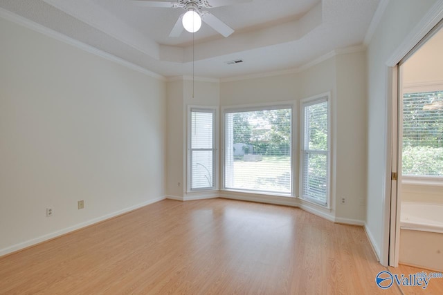 1102 Chesterfield Dr SE, Huntsville, AL 35803 - empty room featuring a tray ceiling, light wood finished floors, ceiling fan, baseboards, and crown molding