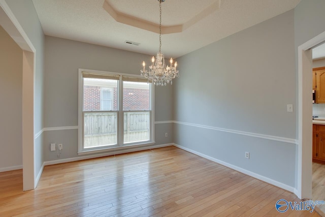 1102 Chesterfield Dr SE, Huntsville, AL 35803 - empty room featuring a chandelier, light wood-type flooring, and baseboards